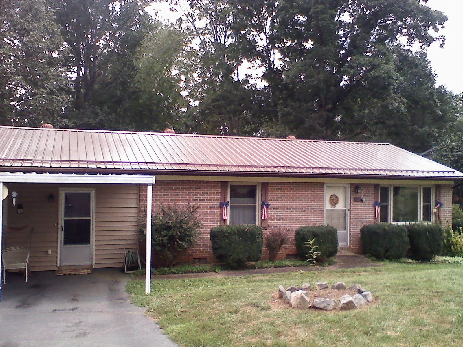 Bronze metal roof and carport on a brick ranch home — Roof Repair work by our crew in Ripley